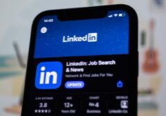 the linkedin logo is displayed on a smartphone